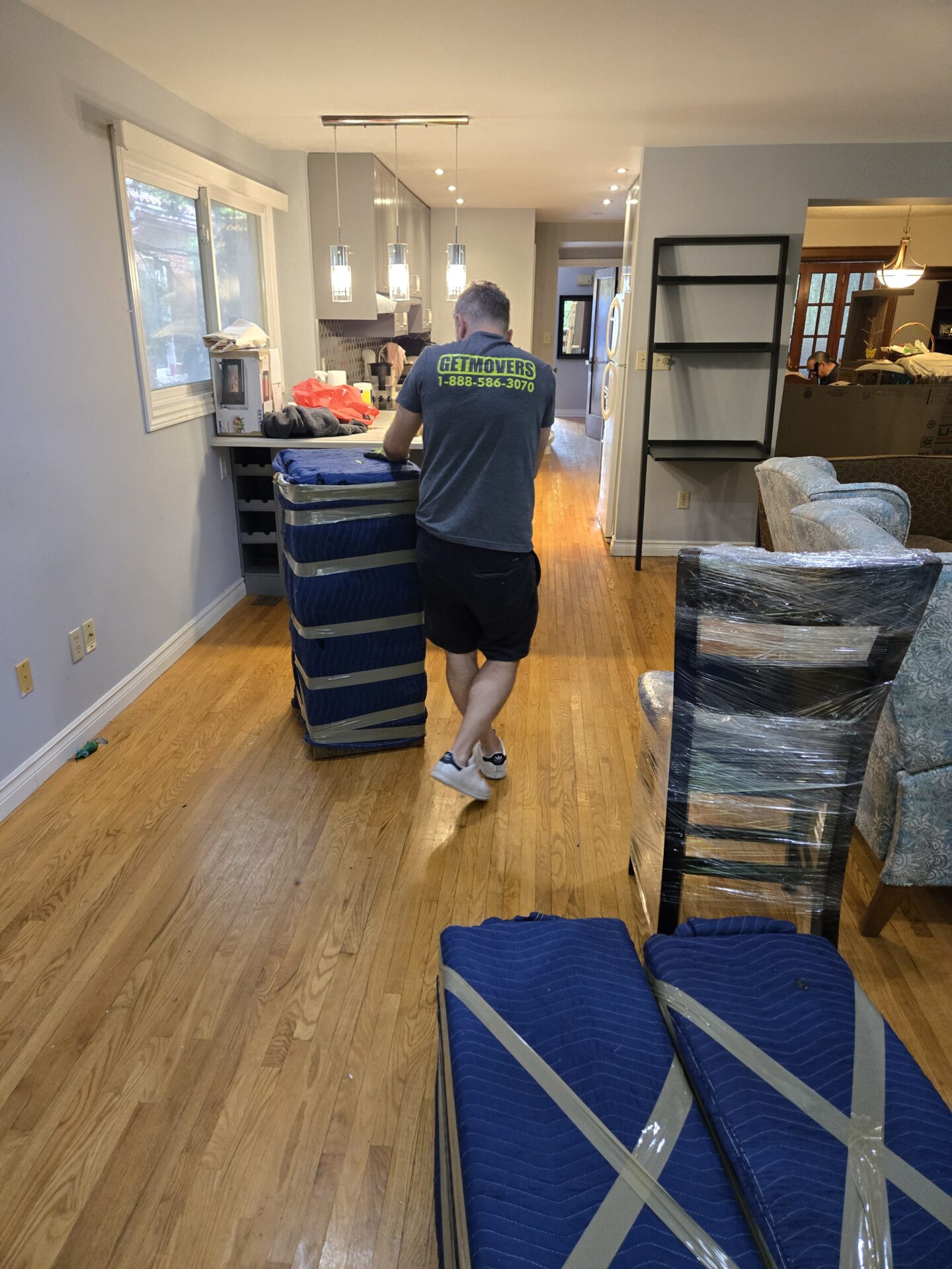 Movers wrapping furniture during a Parkwood move
