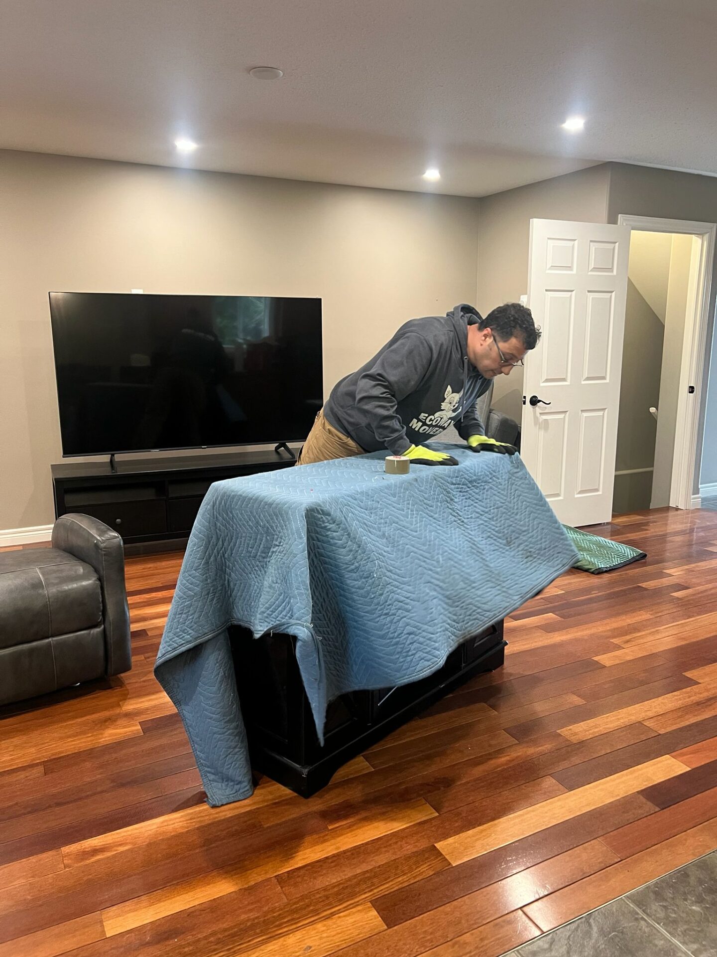 Movers protecting floors in Pinehurst home