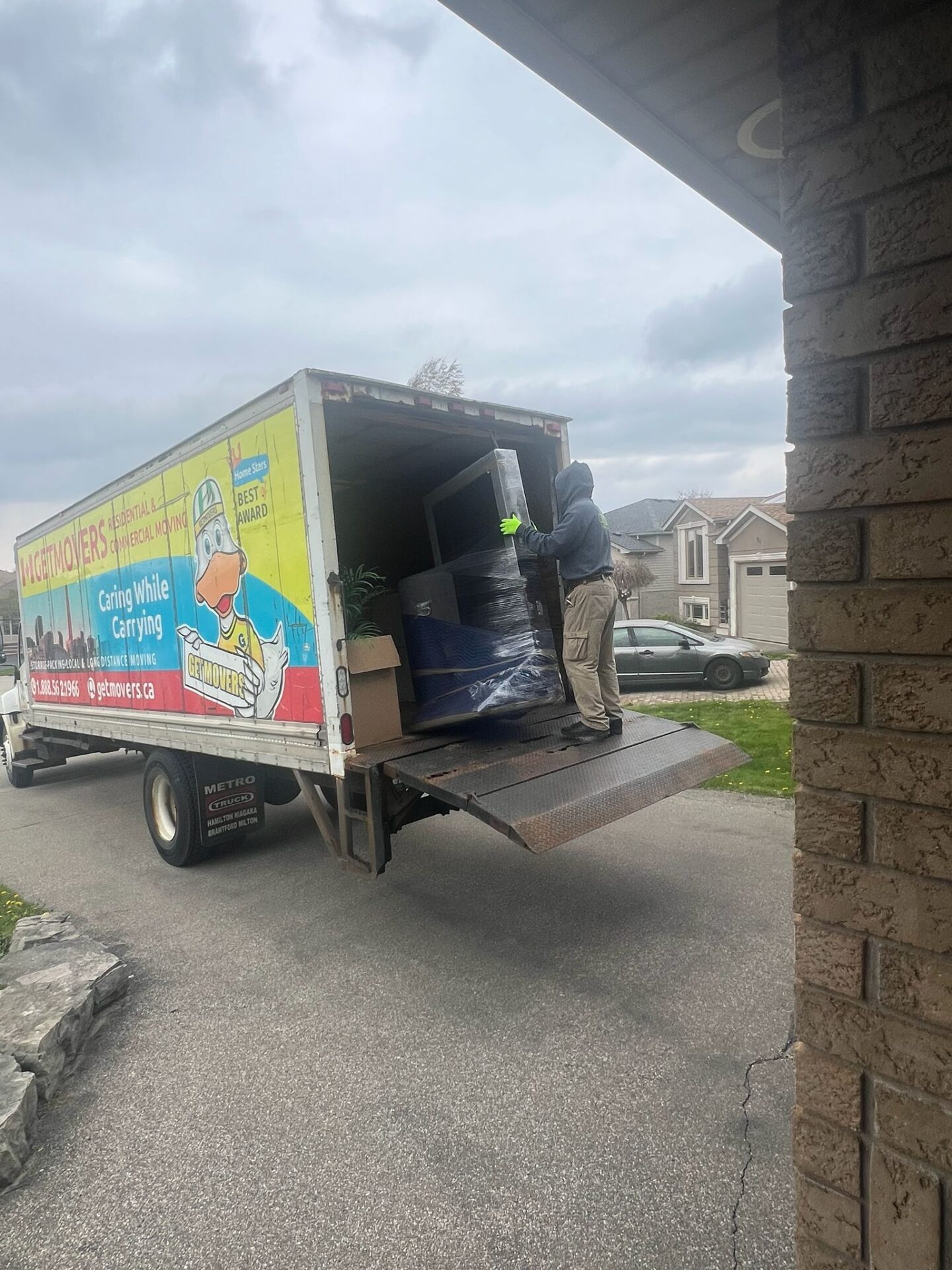 Movers carefully loading office furniture onto the truck