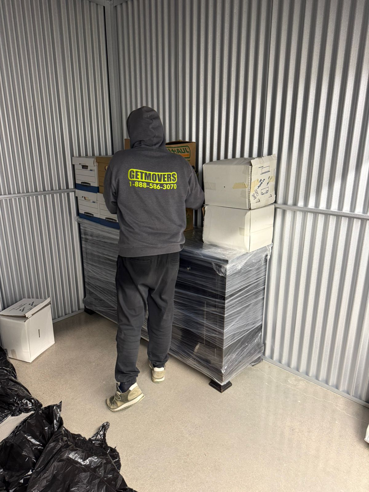 Movers wrapping furniture in a Liverpool heritage home