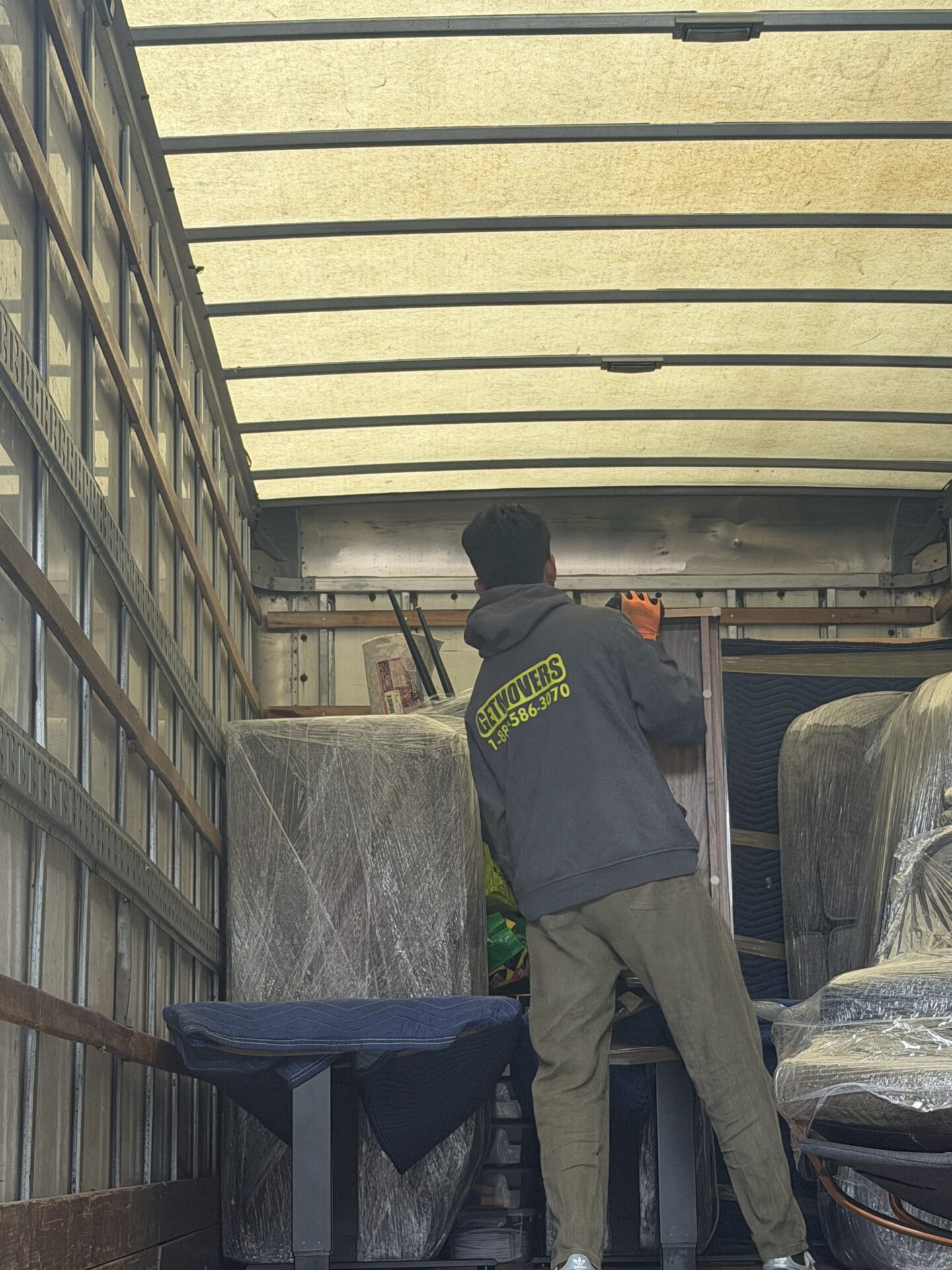 Movers wrapping furniture in Downtown Oshawa condo