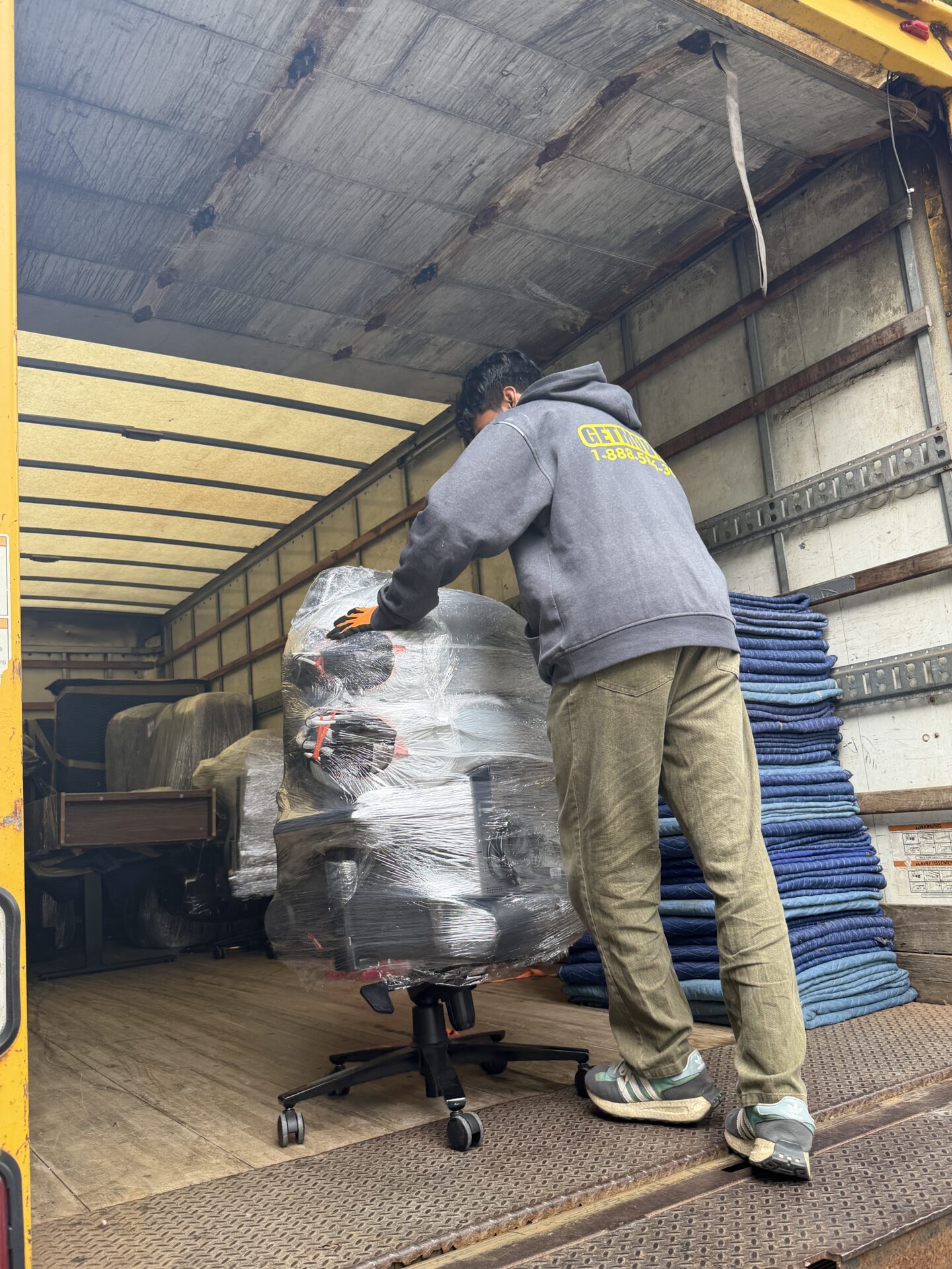Movers protecting hardwood floors in Central Oshawa home