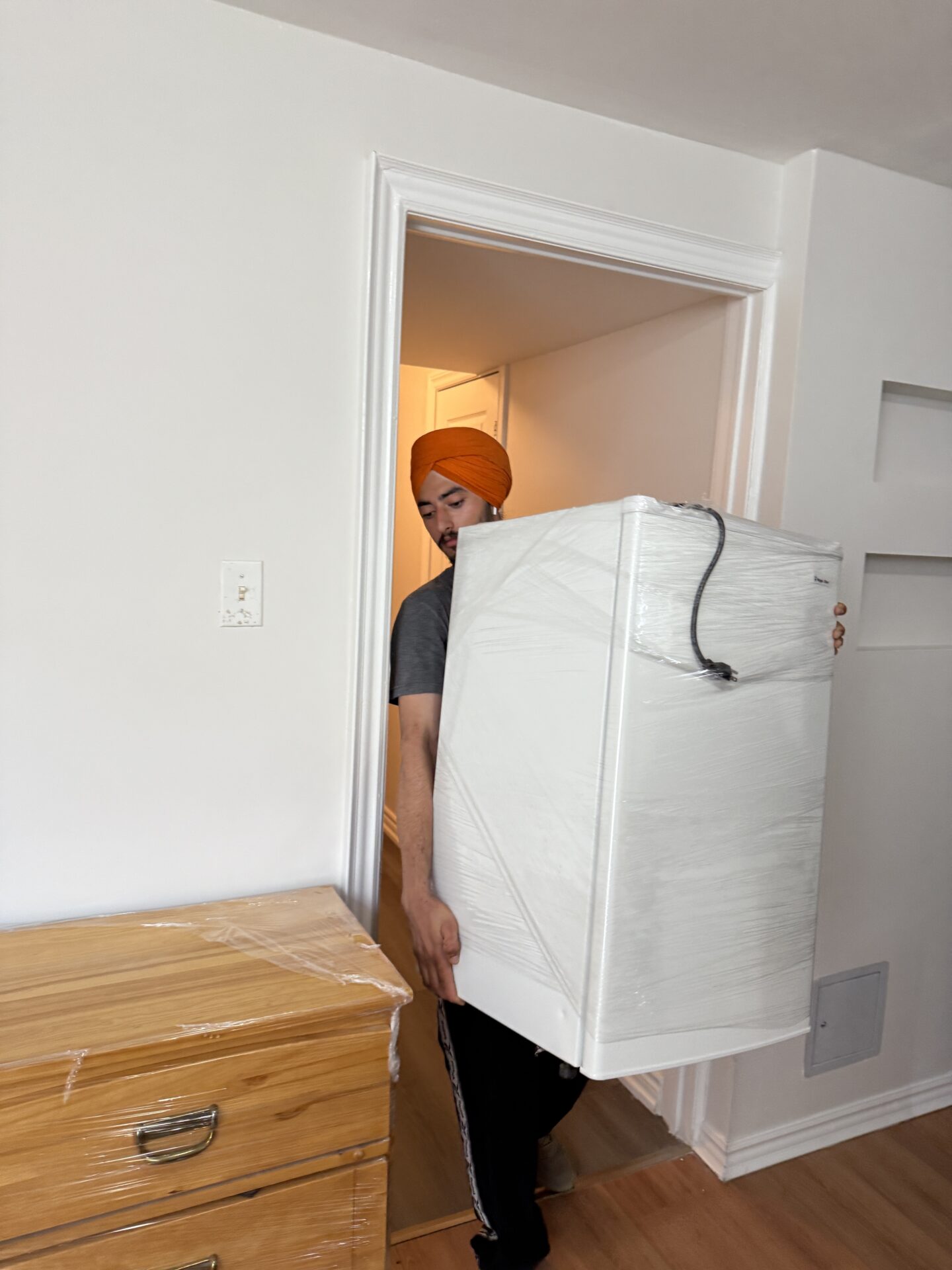 Movers loading boxes from O'Neill walk-up apartment