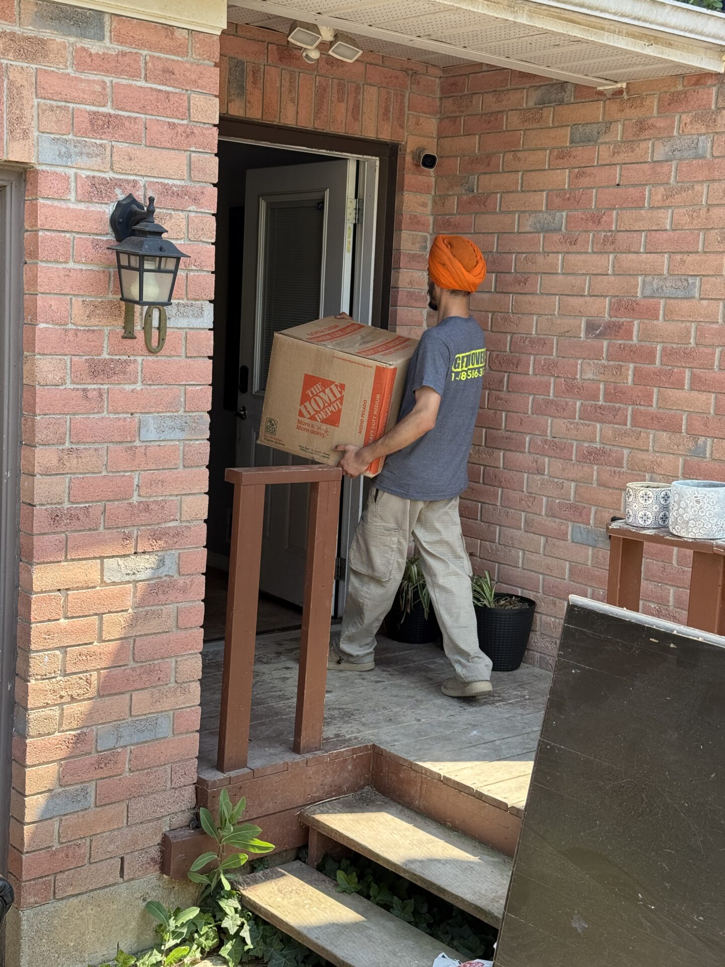 Professional movers staging living room furniture in Kedron