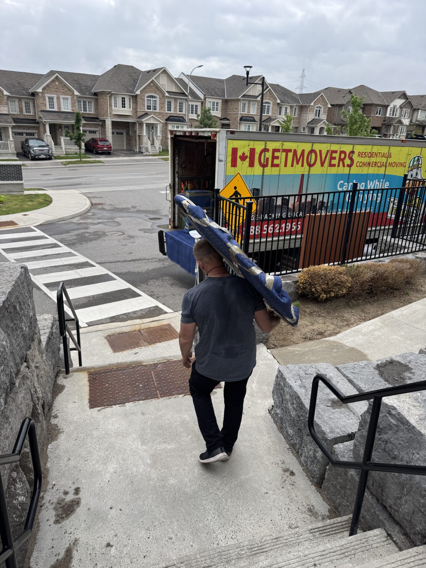 Movers wrapping furniture in Milliken