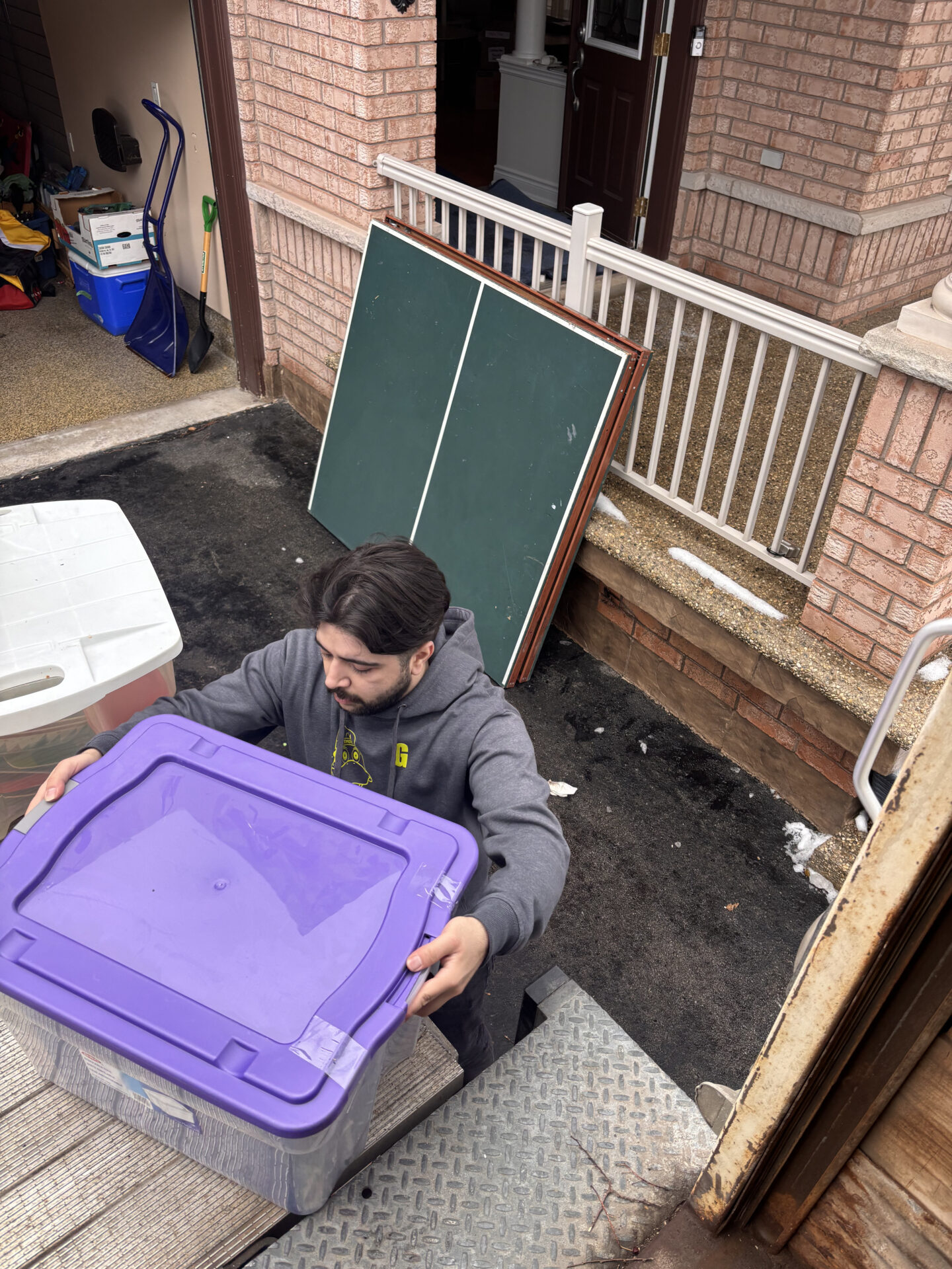 Crew unloading furniture securely at destination in Windfields