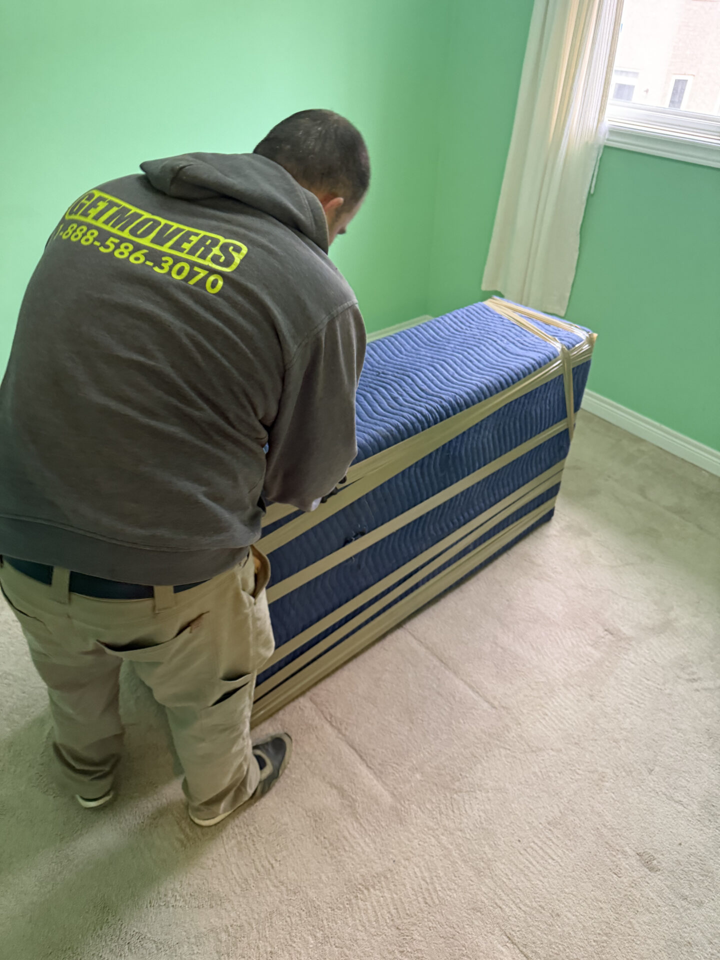 Movers wrapping furniture securely