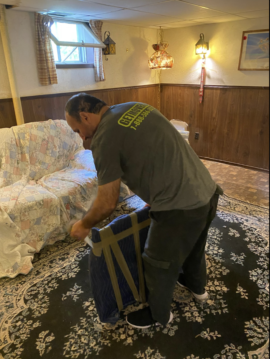 Movers carrying furniture out of Windsor character home