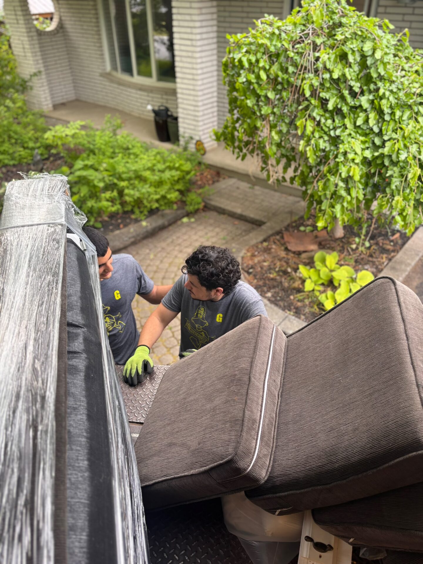 Get Movers Calgary AB professional movers safely loading a 26-foot moving truck during a residential relocation in Taradale, Northeast (NE) Calgary using tailgate lifts