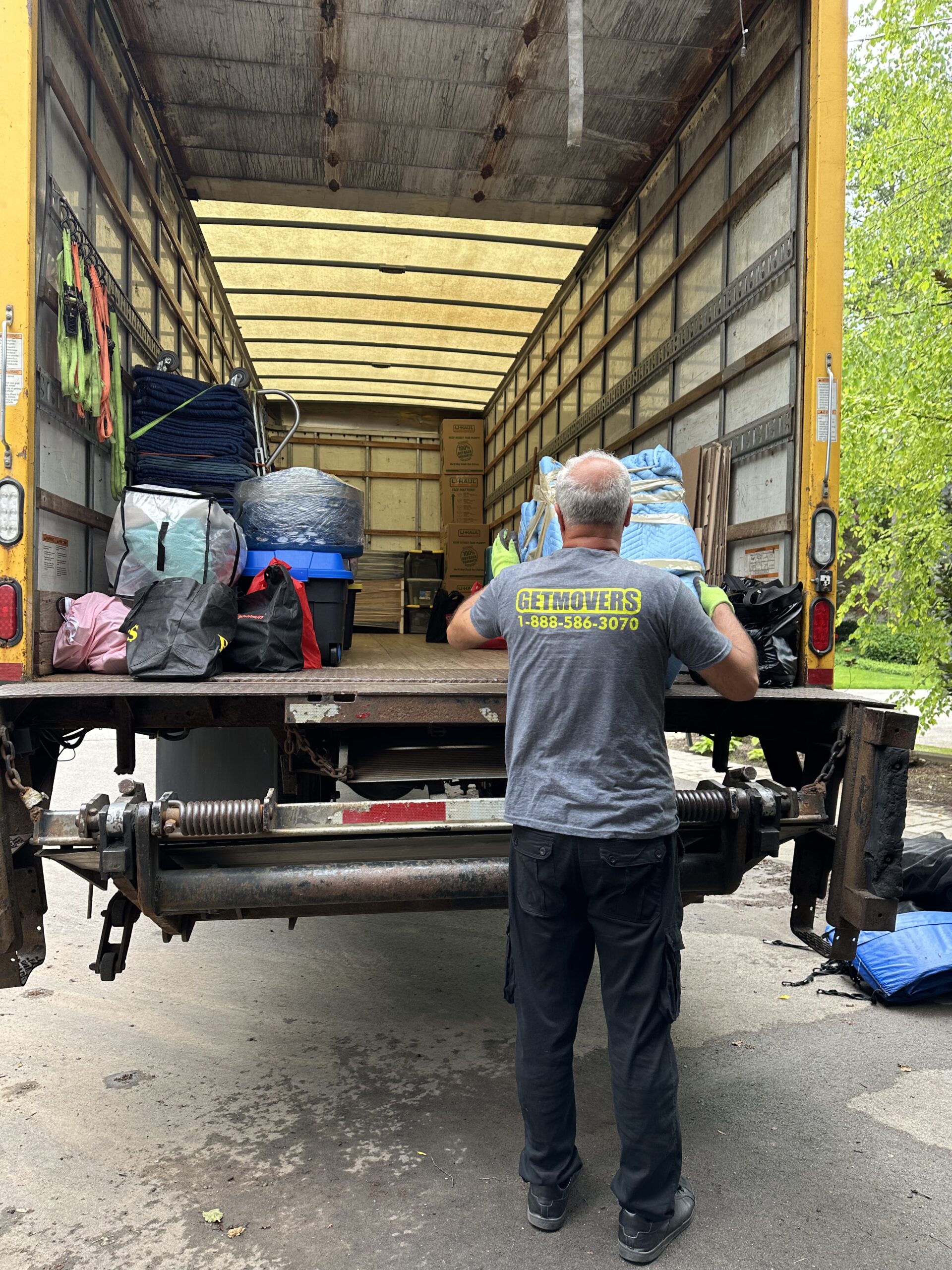 Movers wrapping furniture securely on Astro Street