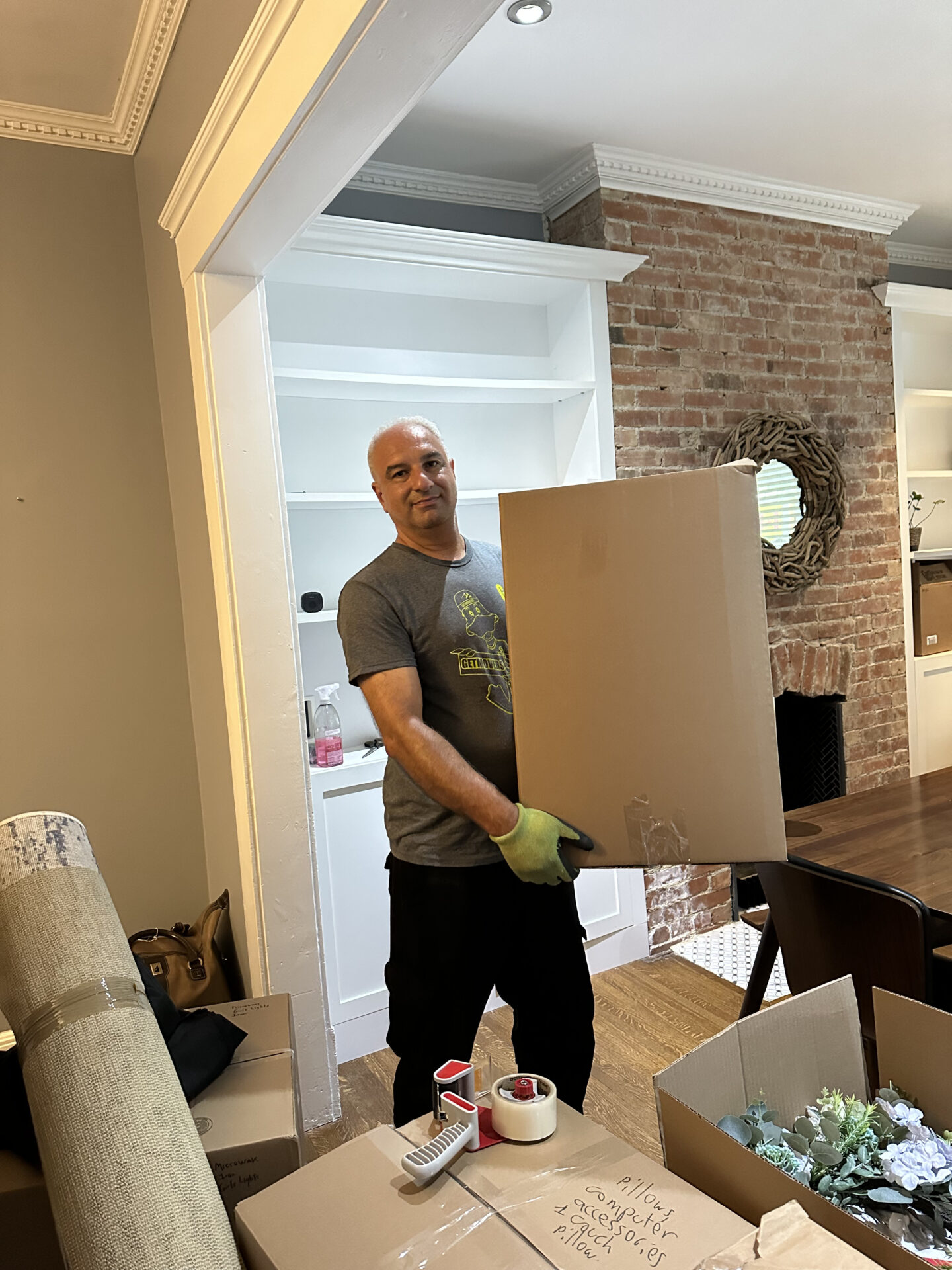 Movers handling heavy boxes on rural property