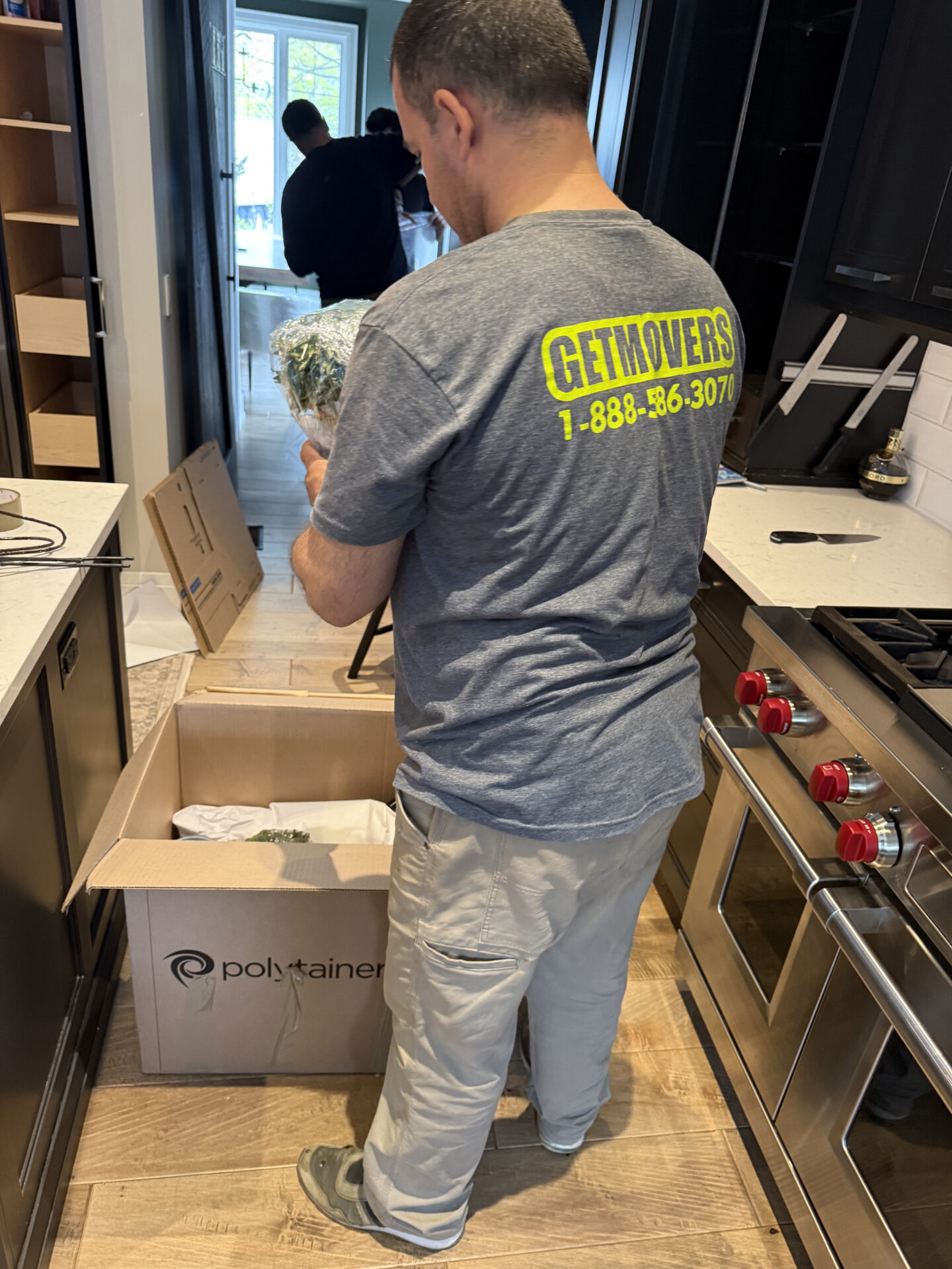 Movers wrapping furniture in Newcastle house
