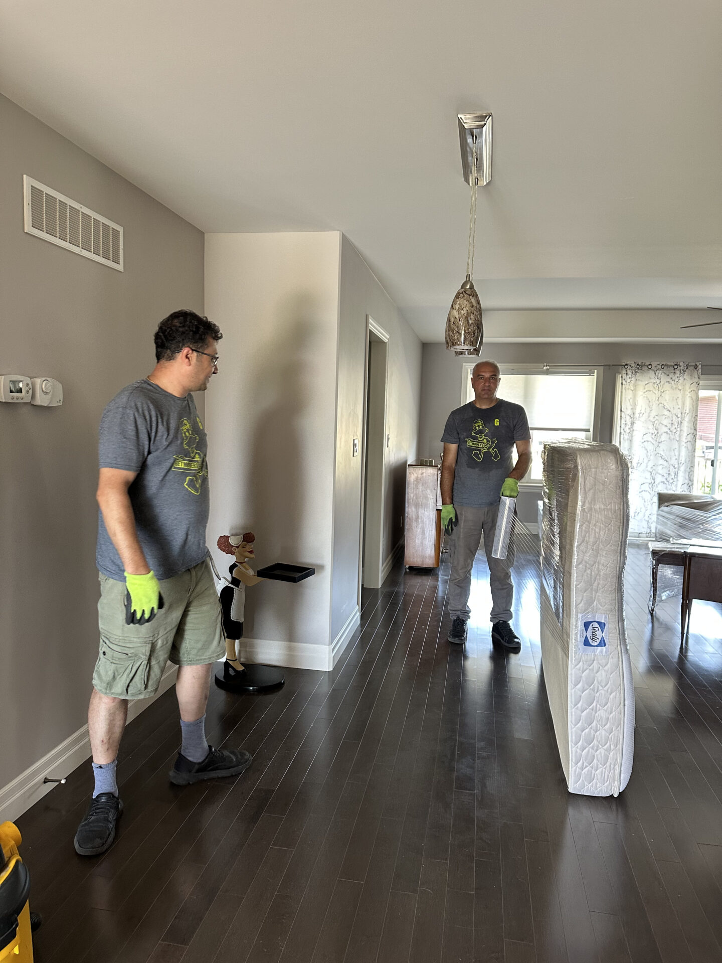 Movers protecting floors and carrying boxes in Clarington