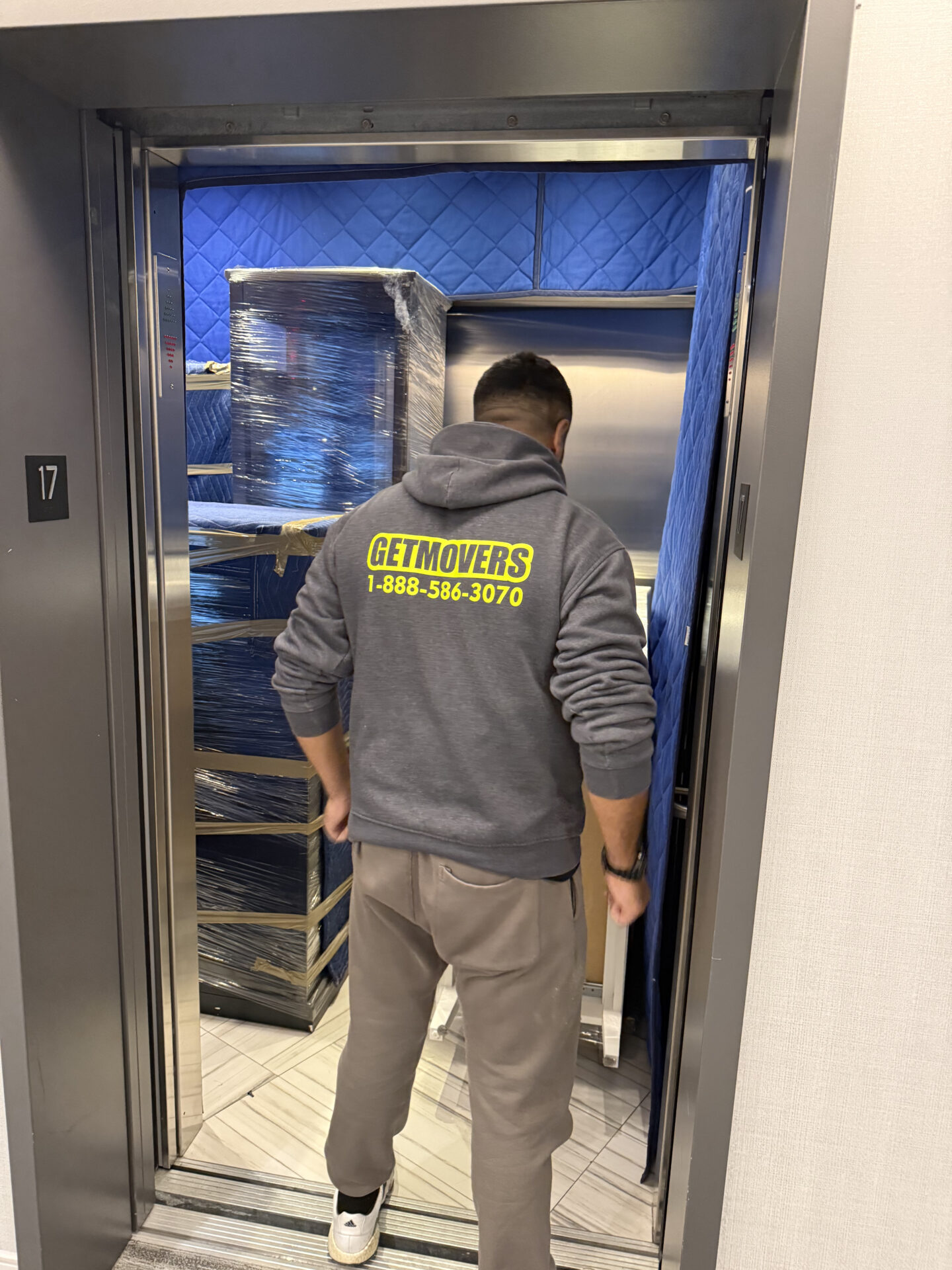 Movers wrapping premium furniture in The Beaches