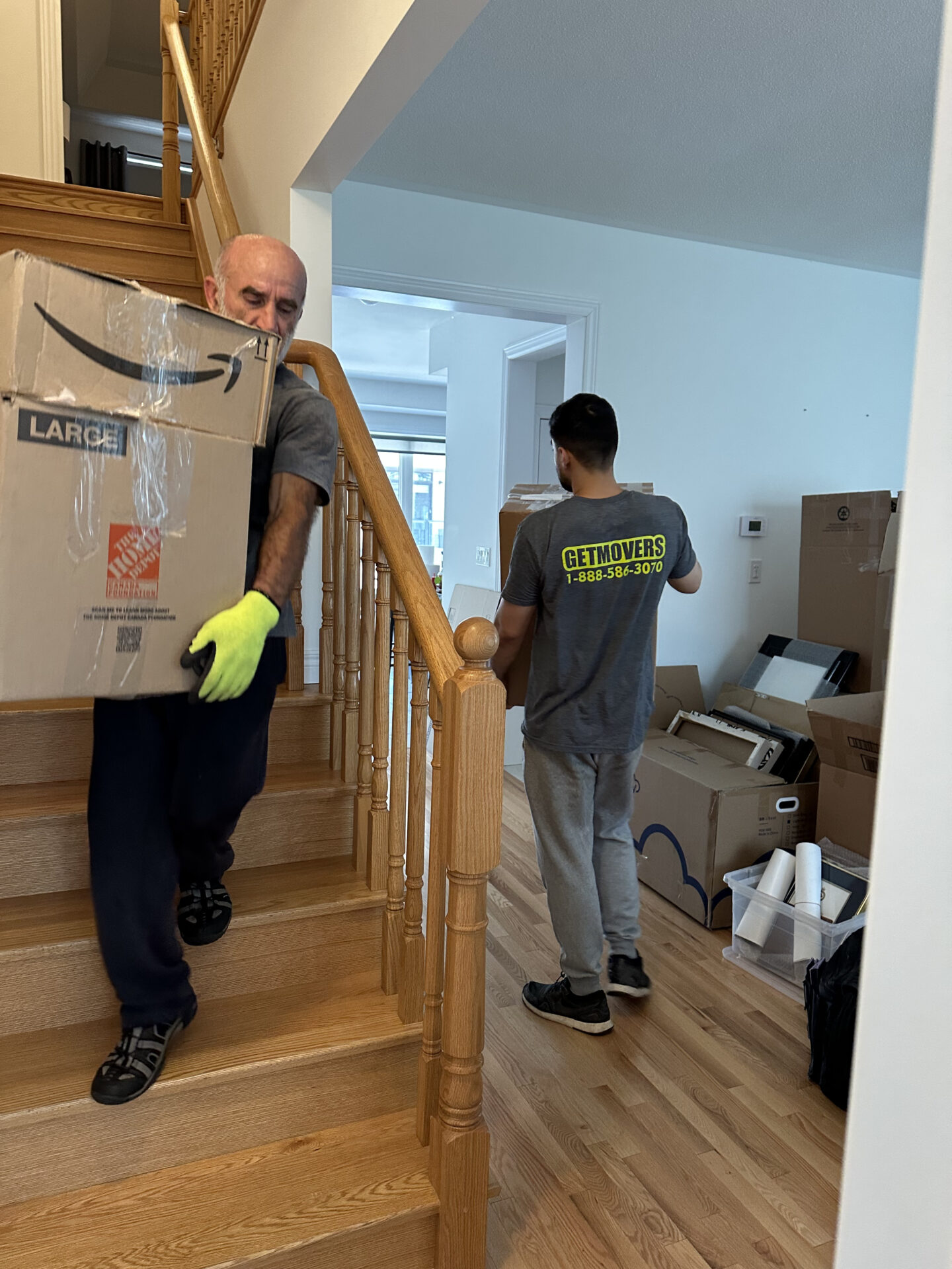 Movers handling heavy furniture on Cedar St
